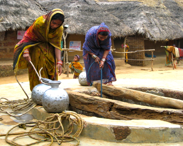 Two women getting water in a seven meter deep well.